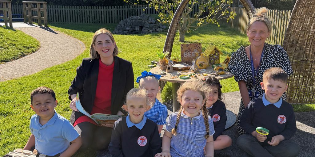 Teachers and pupils sitting outside at Petteril Bank School