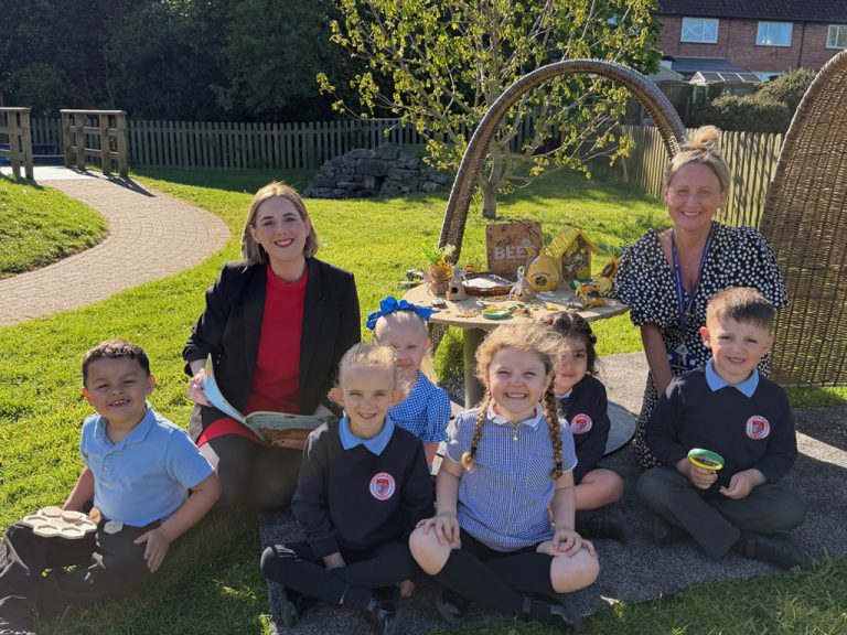 Teachers and pupils sitting outside at Petteril Bank School